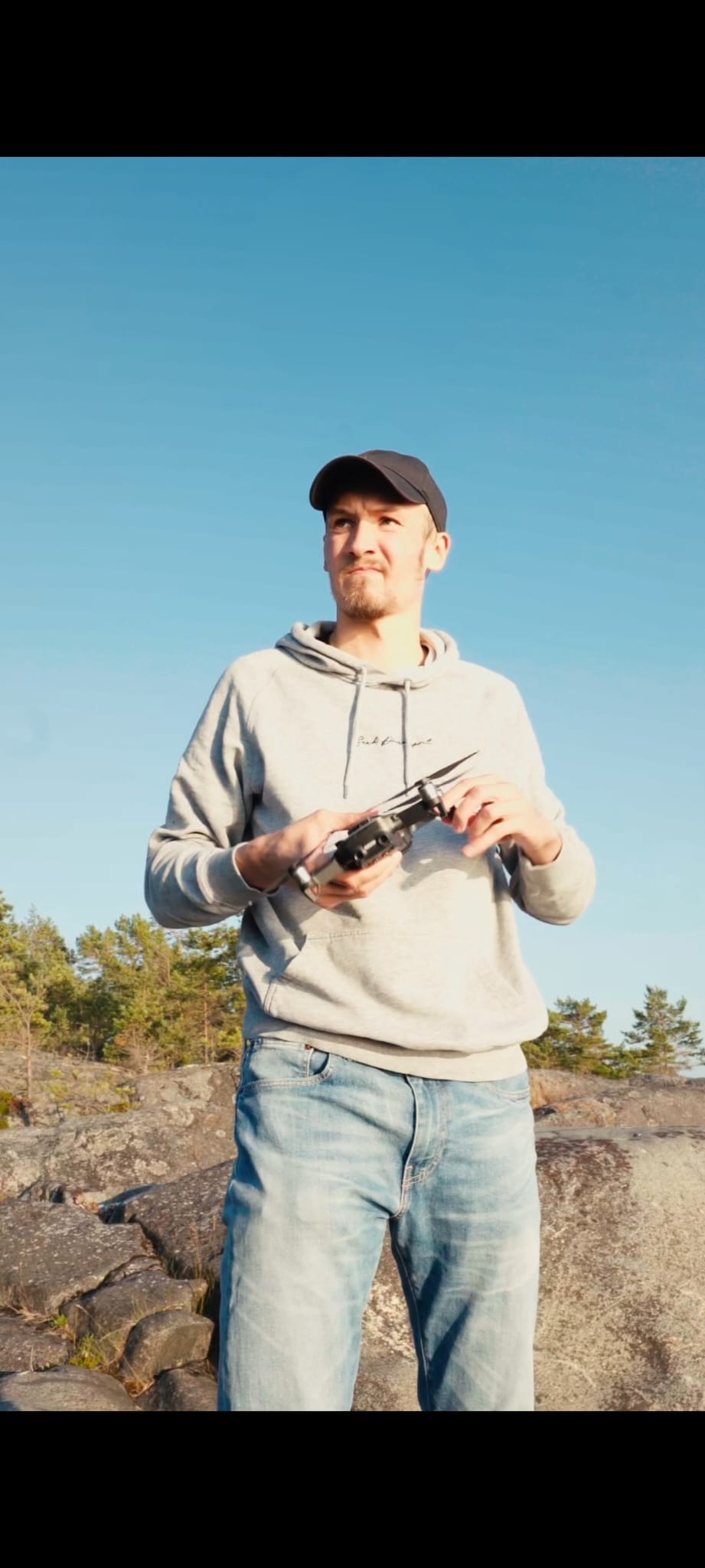 Mika holding a drone camera outdoors